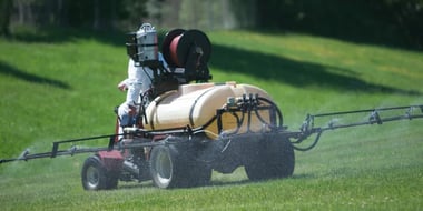 fertilizing-vehicle-spraying-fertilizer-over-grass
